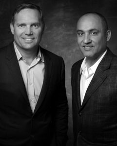 Ray and Corey Hines Chief Executive Officer and the President of Hines Industrial smiling in suits